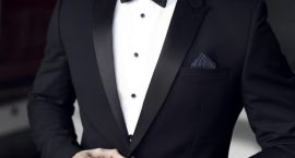 Sexy man in tuxedo and bow tie posing